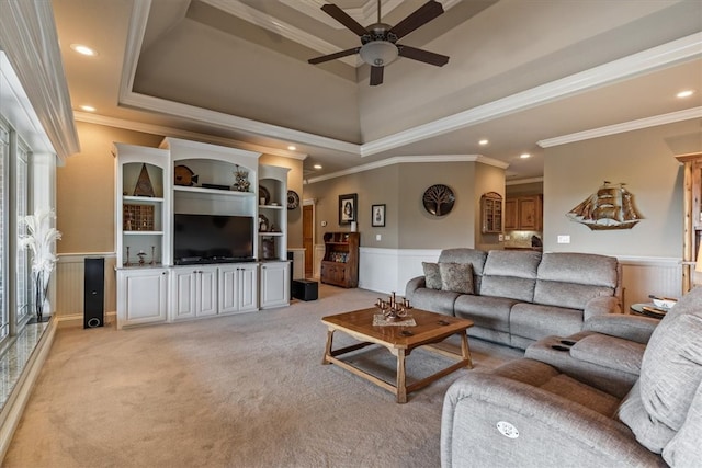 carpeted living room featuring ceiling fan, a healthy amount of sunlight, and crown molding