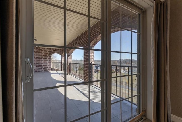 14600 S Mountain, Lowell, AR 72745 - doorway to outside with brick wall, tile patterned flooring, and plenty of natural light