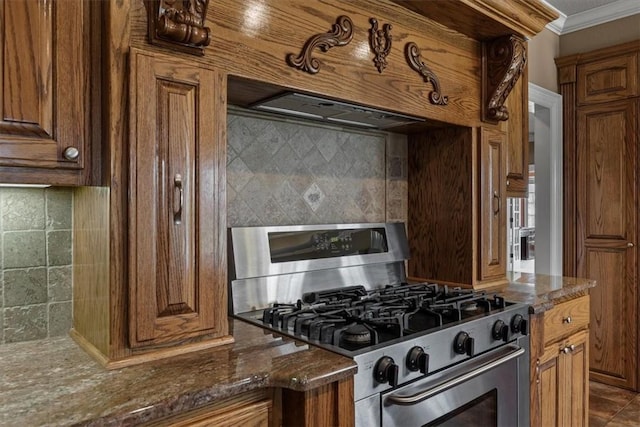 14600 S Mountain, Lowell, AR 72745 - kitchen featuring stainless steel range with gas cooktop, backsplash, crown molding, brown cabinetry, and dark stone countertops