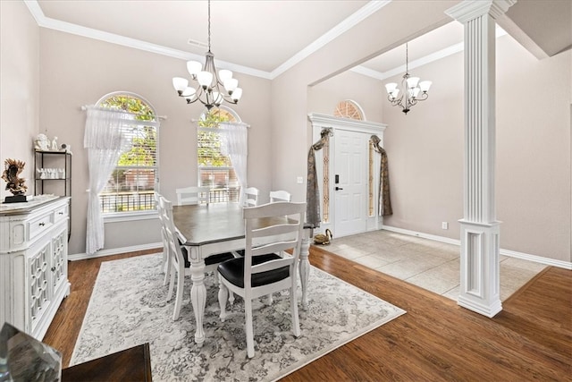 dining space featuring a healthy amount of sunlight, a notable chandelier, and light wood-type flooring