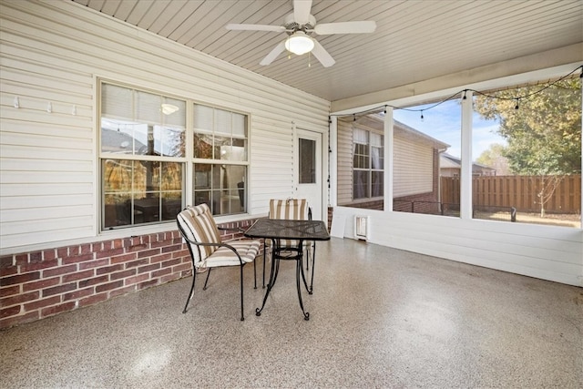 sunroom featuring ceiling fan