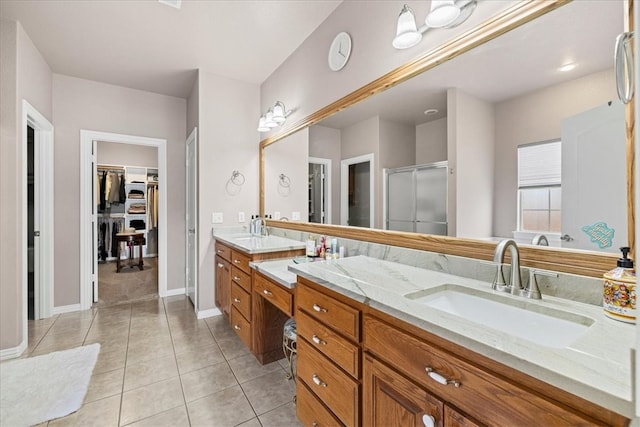 bathroom featuring vanity, tile patterned floors, and a shower with door