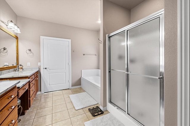 bathroom with tile patterned flooring, vanity, and shower with separate bathtub