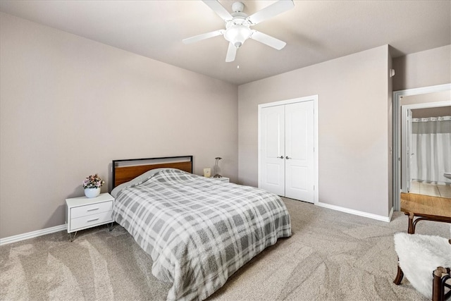 carpeted bedroom with ceiling fan and a closet