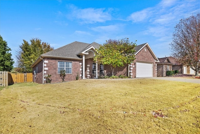 view of front of home with a front yard and a garage