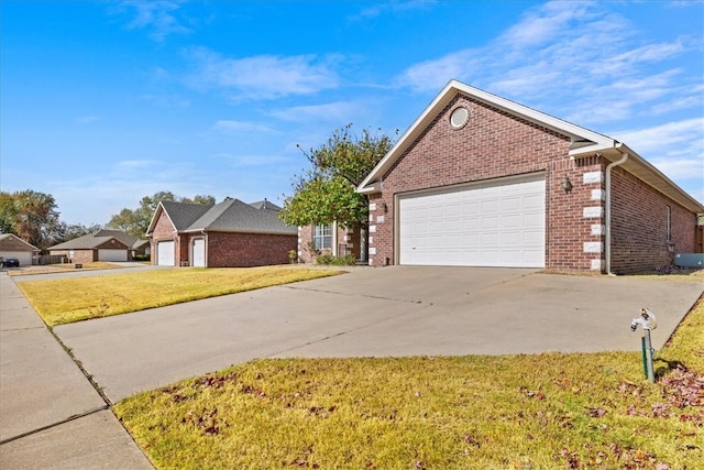 view of side of property with a lawn and a garage