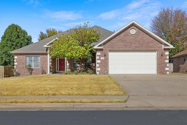 view of front of home with a front yard and a garage