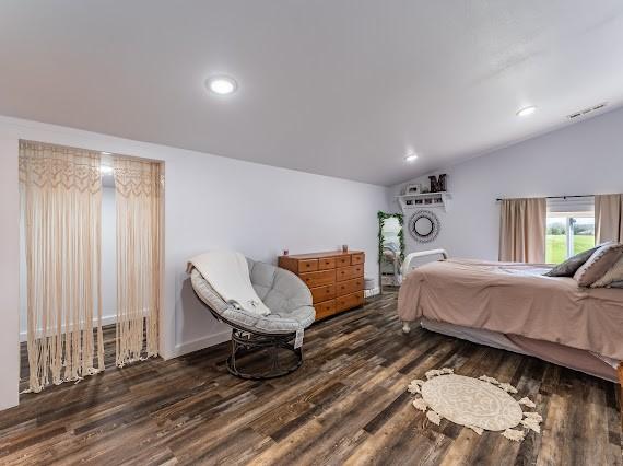 bedroom with lofted ceiling and dark hardwood / wood-style flooring