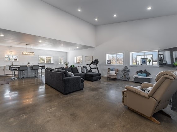 living room with a chandelier and a towering ceiling