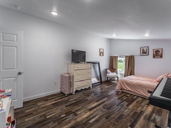 bedroom with lofted ceiling and dark hardwood / wood-style floors