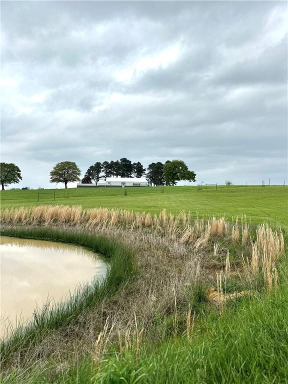 view of local wilderness with a rural view and a water view