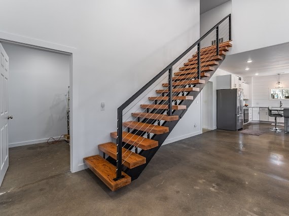 stairway featuring concrete floors