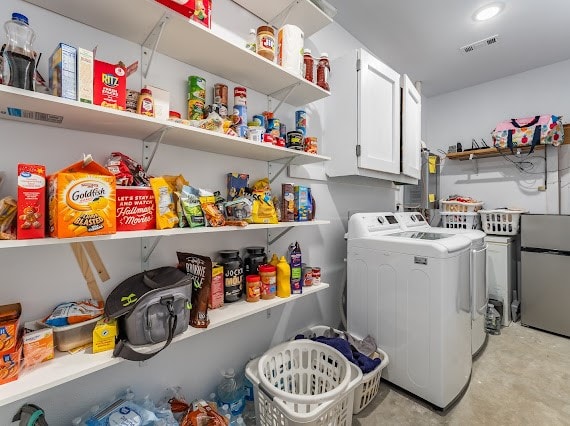 clothes washing area featuring independent washer and dryer