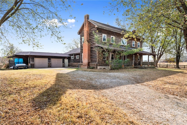 cabin with covered porch and a garage