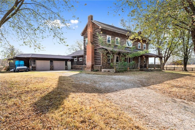 18405 Rheas Community Rd, Lincoln, AR 72744 - view of side of home with stone siding, a porch, a chimney, driveway, and a garage
