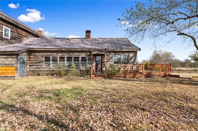 18405 Rheas Community Rd, Lincoln, AR 72744 - rear view of property with a wooden deck, a chimney, and a lawn