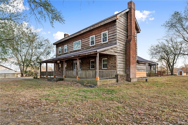 view of front of house with covered porch and a front yard