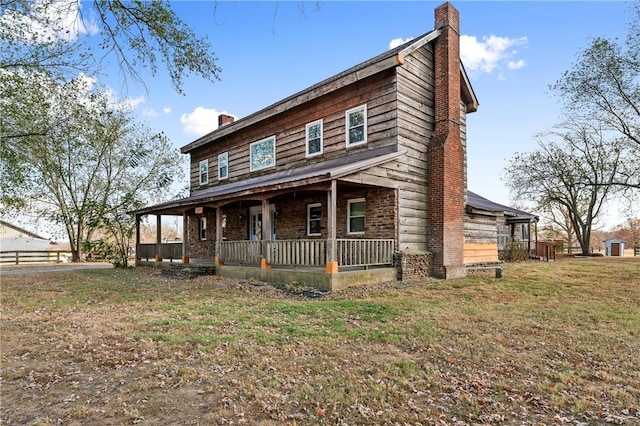 18405 Rheas Community Rd, Lincoln, AR 72744 - view of front of home with a chimney, covered porch, and a front lawn
