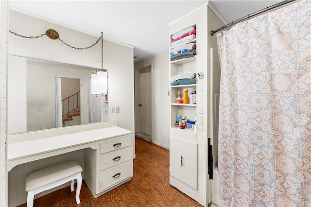 bathroom with a textured ceiling, shower / bath combo, hardwood / wood-style floors, vanity, and ornamental molding