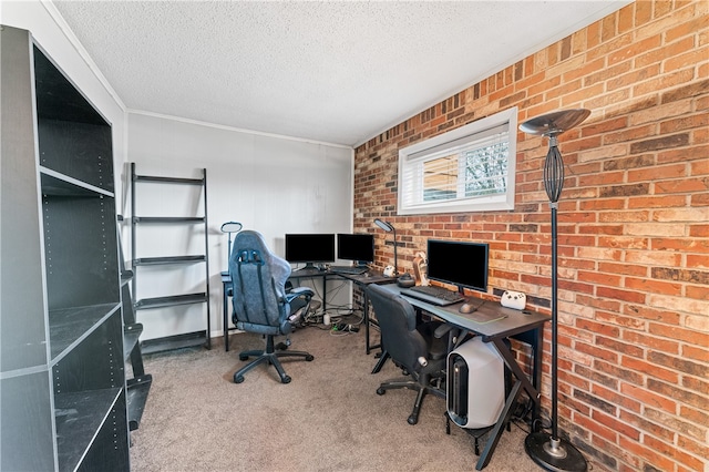 home office featuring brick wall, carpet flooring, and a textured ceiling