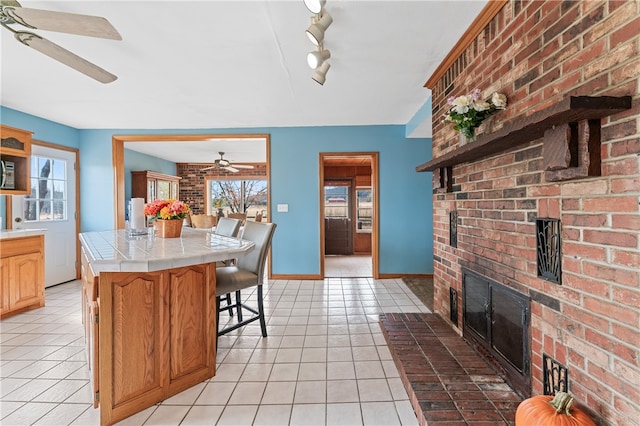 kitchen featuring tile countertops, light tile patterned flooring, and plenty of natural light