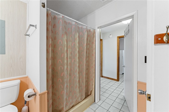 bathroom featuring toilet, tile patterned floors, walk in shower, and a textured ceiling