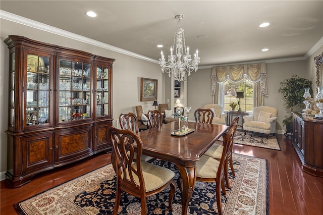 dining space featuring dark wood-type flooring, crown molding, and an inviting chandelier