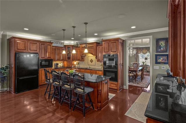 kitchen featuring a breakfast bar area, black appliances, a center island, dark hardwood / wood-style flooring, and tasteful backsplash