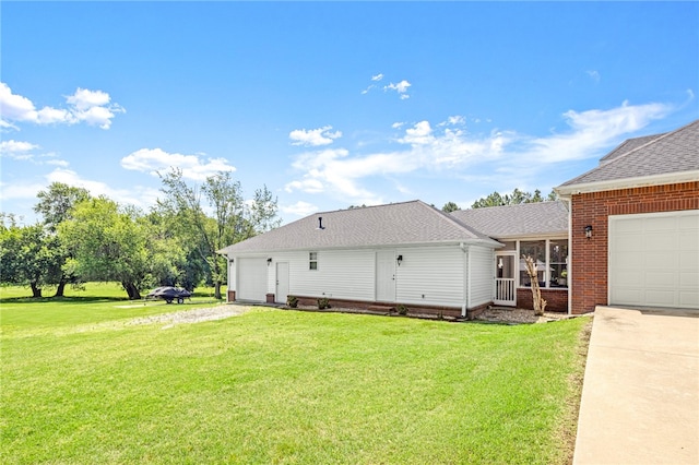 view of side of property with a lawn and a garage