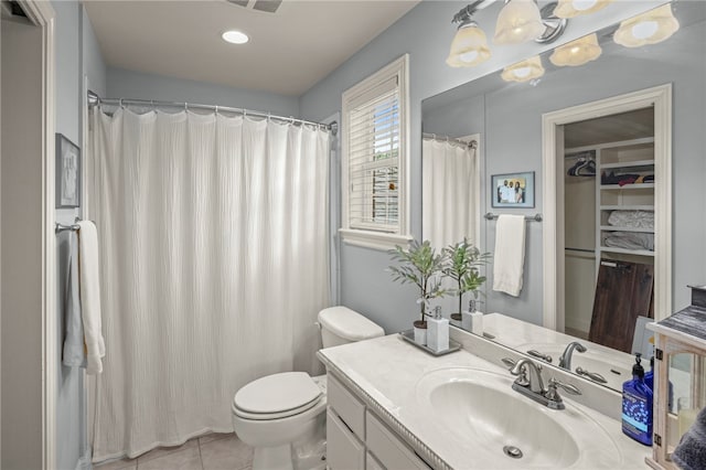 bathroom with vanity, toilet, and tile patterned floors