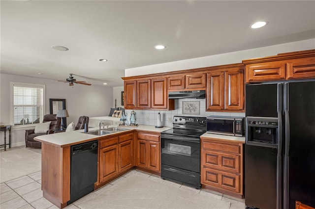 kitchen with black appliances, sink, kitchen peninsula, ceiling fan, and light carpet