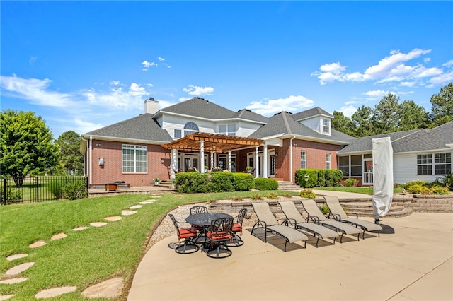 back of house with a patio, a lawn, and a pergola