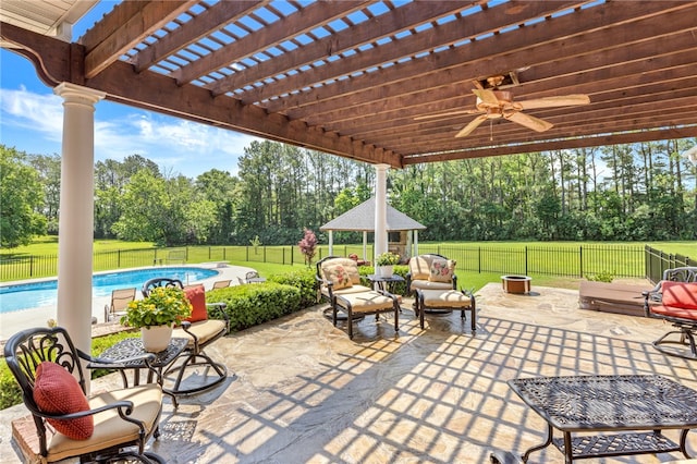 view of patio featuring a pergola, a gazebo, ceiling fan, a fenced in pool, and an outdoor living space