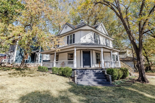 farmhouse-style home featuring a porch and a front yard