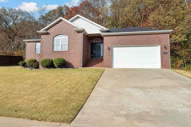 view of front of property with a front yard and a garage