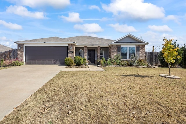 ranch-style house featuring a front yard and a garage