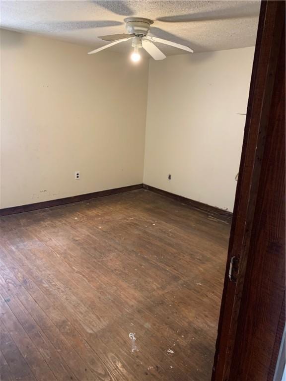 2377 Jordan Rd, Jordan, AR 72658 - empty room featuring a ceiling fan, dark wood-style floors, a textured ceiling, and baseboards