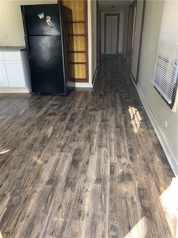 2377 Jordan Rd, Jordan, AR 72658 - corridor featuring dark wood-style floors and baseboards