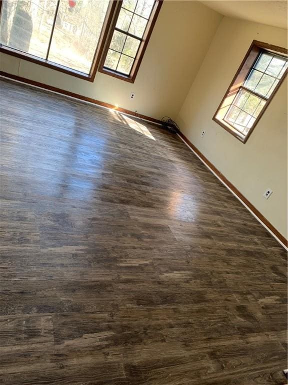 2377 Jordan Rd, Jordan, AR 72658 - empty room with healthy amount of natural light, dark wood-type flooring, and baseboards