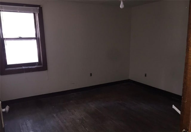 2377 Jordan Rd, Jordan, AR 72658 - empty room featuring dark wood-type flooring and baseboards