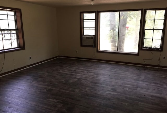 unfurnished room with cooling unit and dark hardwood / wood-style flooring