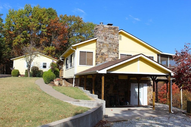 view of front of home with a front yard, stone siding, a chimney, and stucco siding