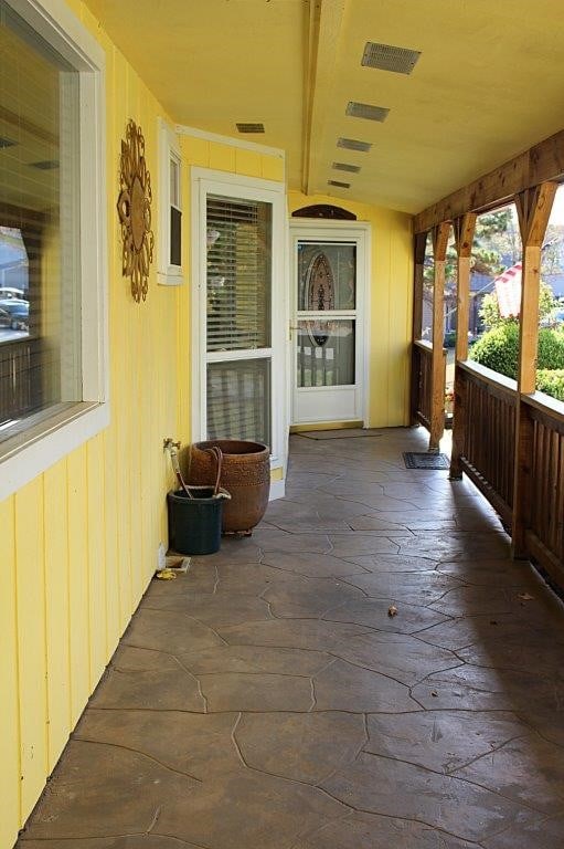 18960 Coppermine Rd, Rogers, AR 72756 - view of patio featuring covered porch and visible vents