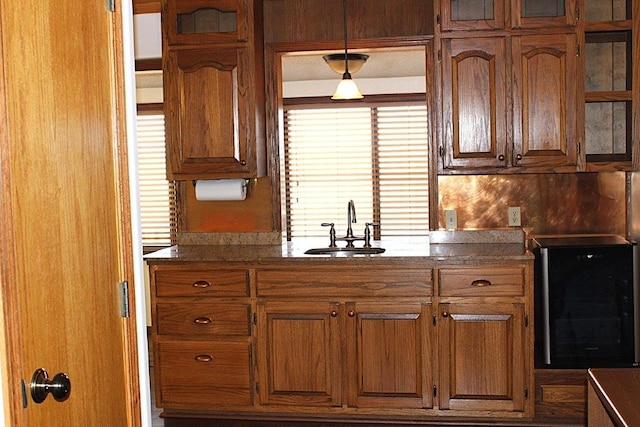 18960 Coppermine Rd, Rogers, AR 72756 - kitchen with glass insert cabinets, brown cabinetry, and a sink