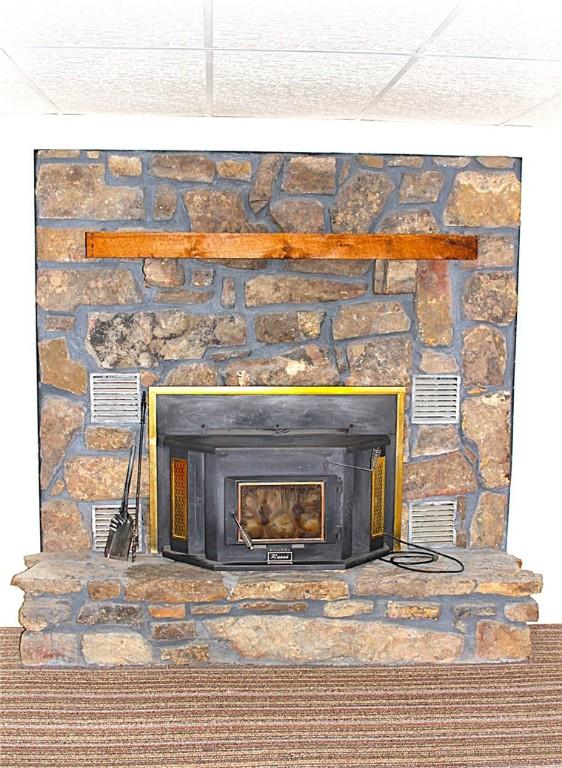 18960 Coppermine Rd, Rogers, AR 72756 - interior details featuring visible vents and a wood stove