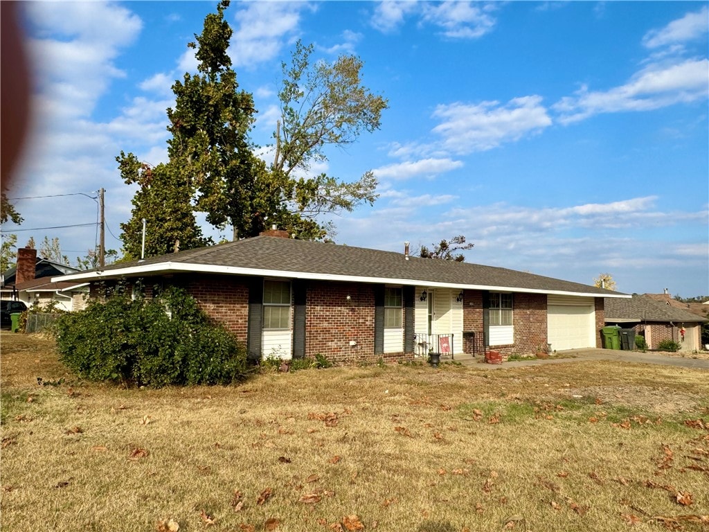 view of front facade with a front lawn and a garage