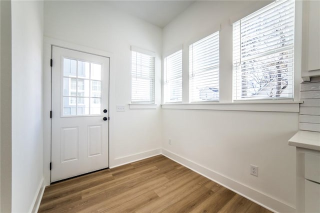 doorway with hardwood / wood-style flooring