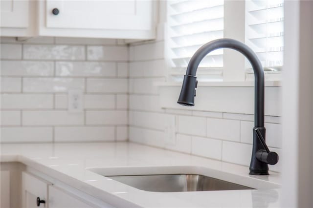 details with white cabinets and sink