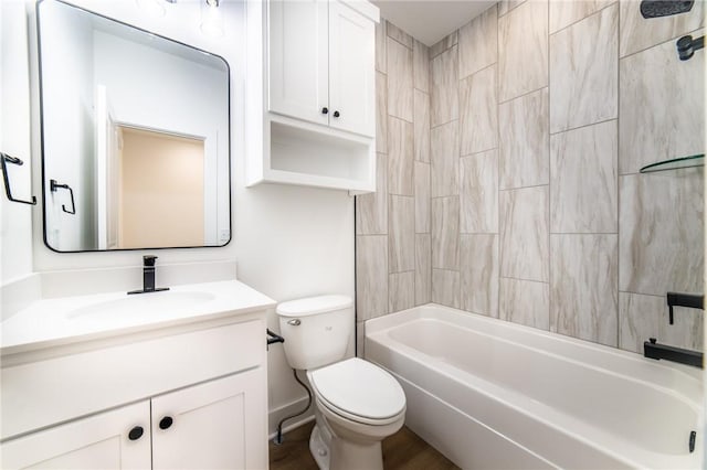 full bathroom with vanity, tiled shower / bath combo, and toilet