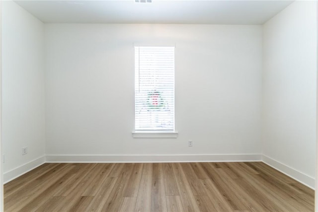 unfurnished room with light wood-type flooring